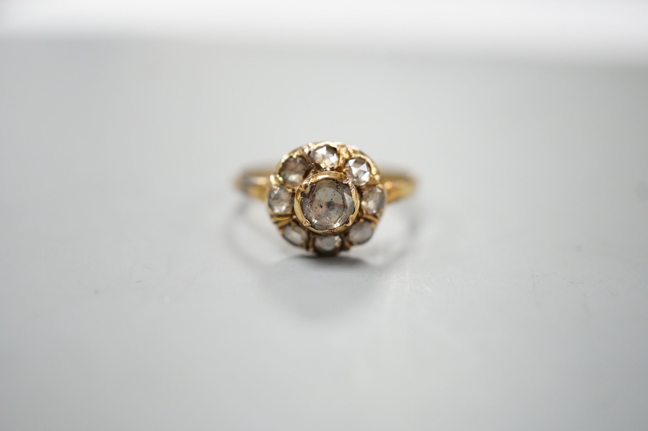 An antique yellow metal and rose cut diamond cluster set ring, size K/L, gross weight 3.2 grams.